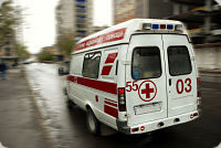 Picture of an Ambulance in motion on a street in the City
